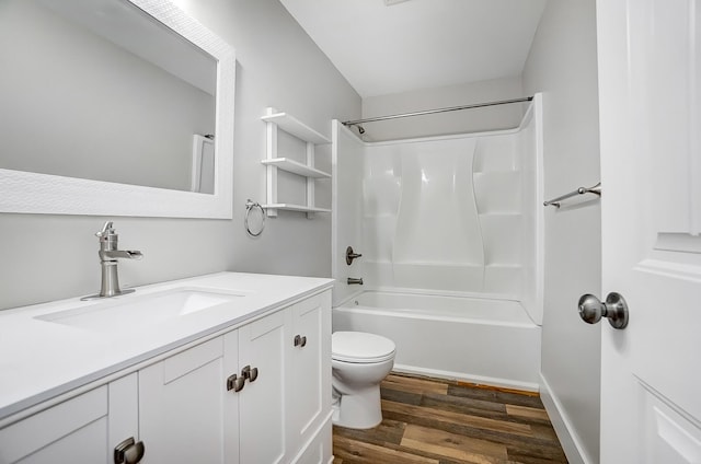 bathroom featuring vanity, shower / bathing tub combination, wood finished floors, and toilet