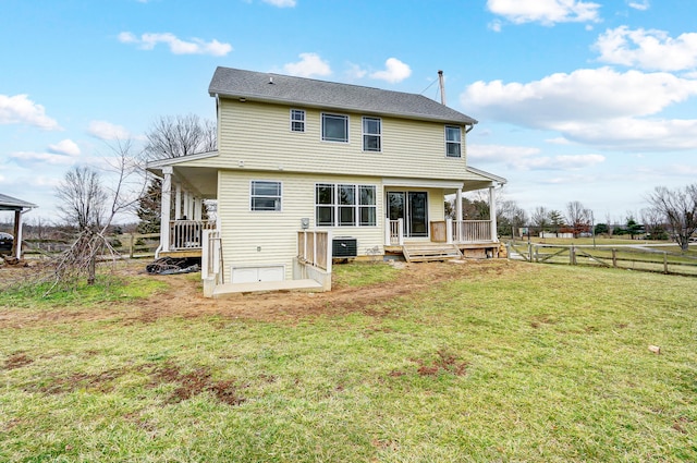 back of house featuring cooling unit, a lawn, a wooden deck, and fence