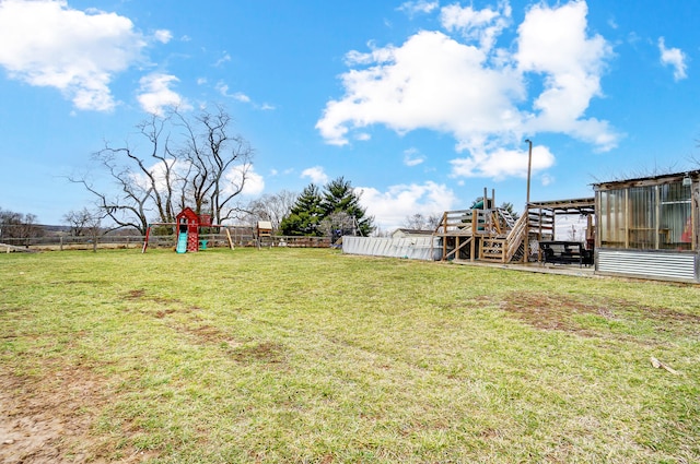 view of yard with a fenced backyard and a playground