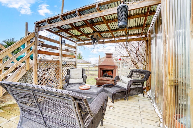 wooden deck with an outdoor living space with a fireplace