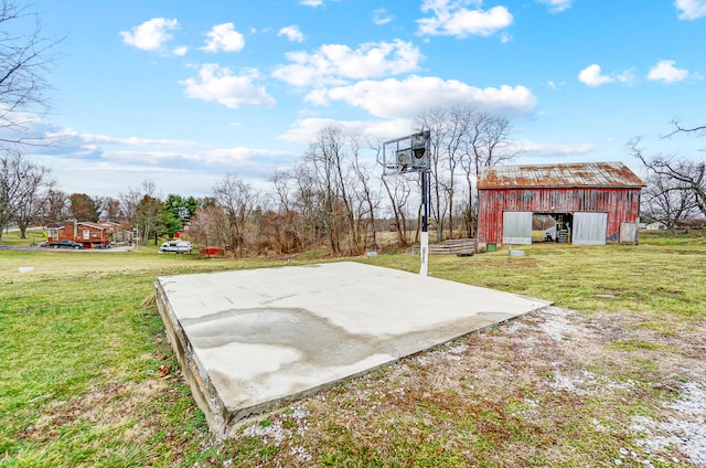 view of patio / terrace featuring a garage and an outbuilding