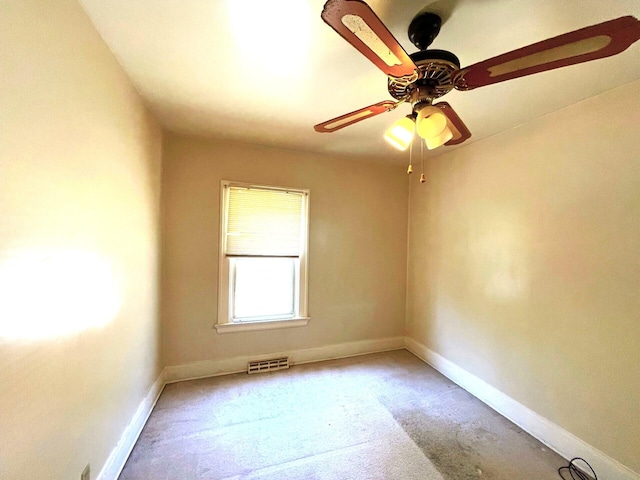 unfurnished room with baseboards, visible vents, and carpet