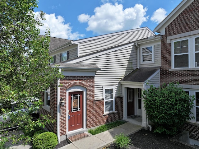 property entrance with brick siding