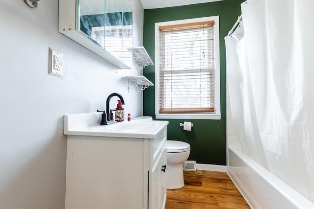 full bath with baseboards, vanity, toilet, and wood finished floors