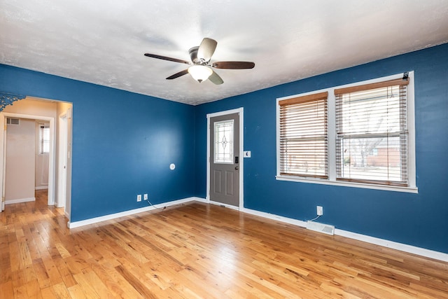 entryway featuring plenty of natural light, light wood-style flooring, and baseboards