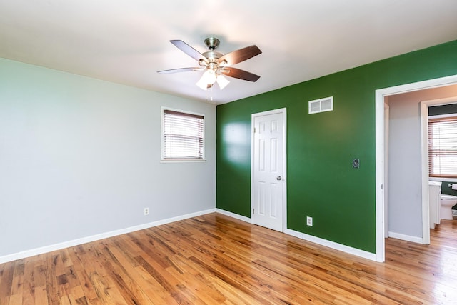 unfurnished bedroom with baseboards, visible vents, a ceiling fan, light wood-type flooring, and a closet