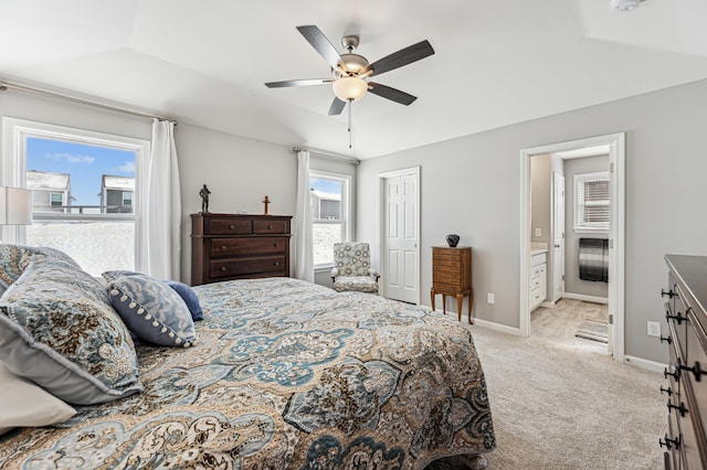 bedroom with ensuite bathroom, ceiling fan, and light colored carpet