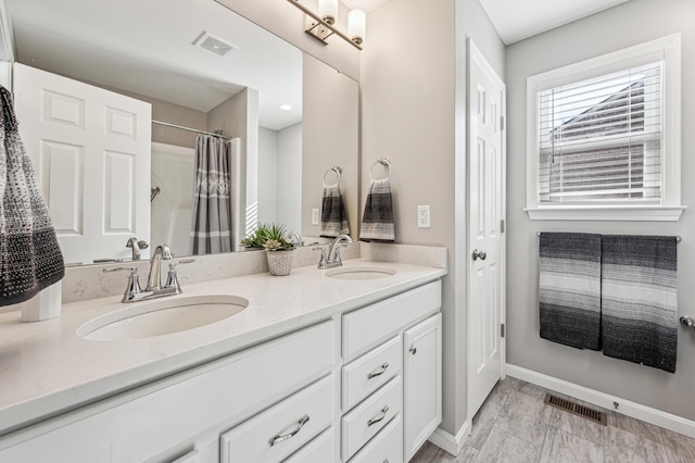 bathroom featuring vanity and a shower with shower curtain