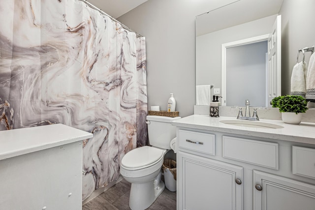 bathroom featuring vanity and toilet