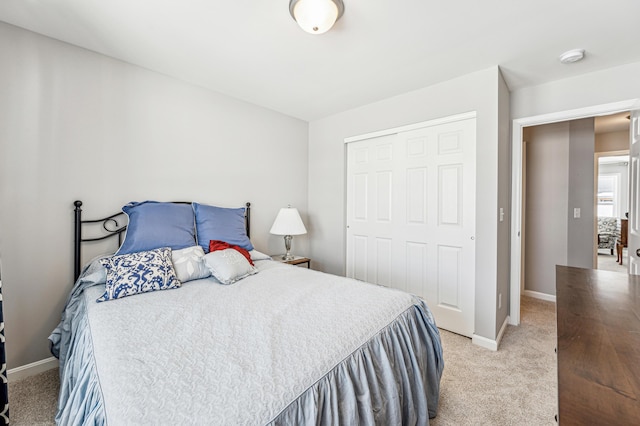 bedroom featuring a closet and light colored carpet