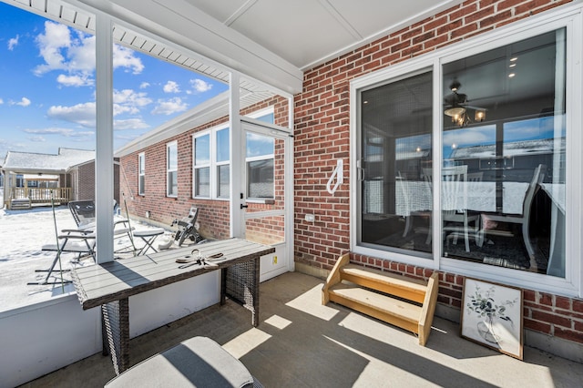 sunroom / solarium featuring ceiling fan