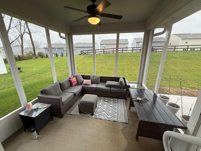 sunroom / solarium featuring ceiling fan and a healthy amount of sunlight