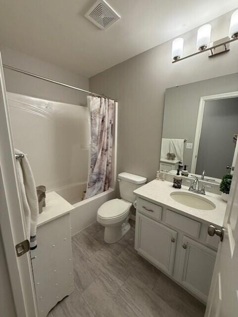 full bathroom with shower / tub combo, vanity, and toilet