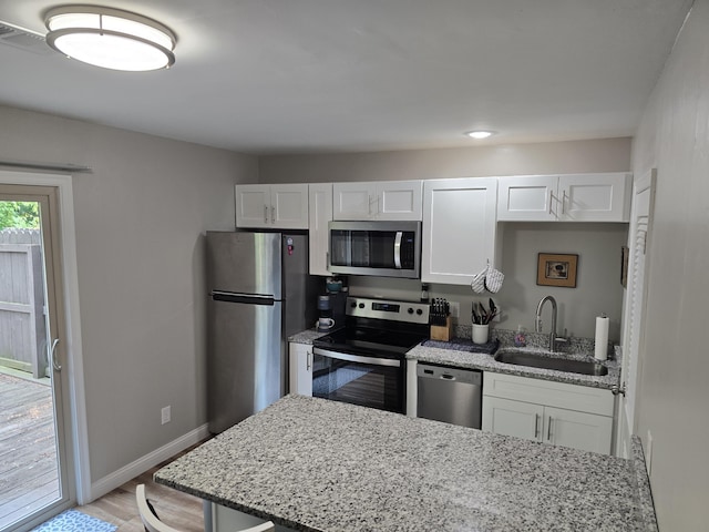7013 Curtis Way Unit 7013, Florence, KY 41042 - kitchen featuring stainless steel appliances, white cabinets, light stone counters, and light wood finished floors