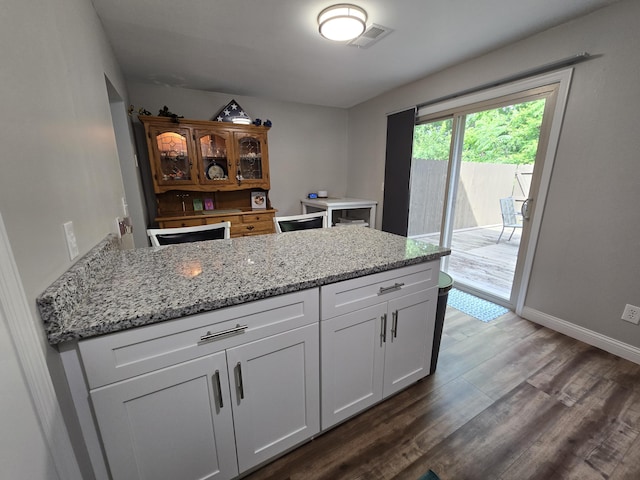 7013 Curtis Way Unit 7013, Florence, KY 41042 - kitchen featuring dark wood-style floors, white cabinetry, light stone countertops, and a peninsula