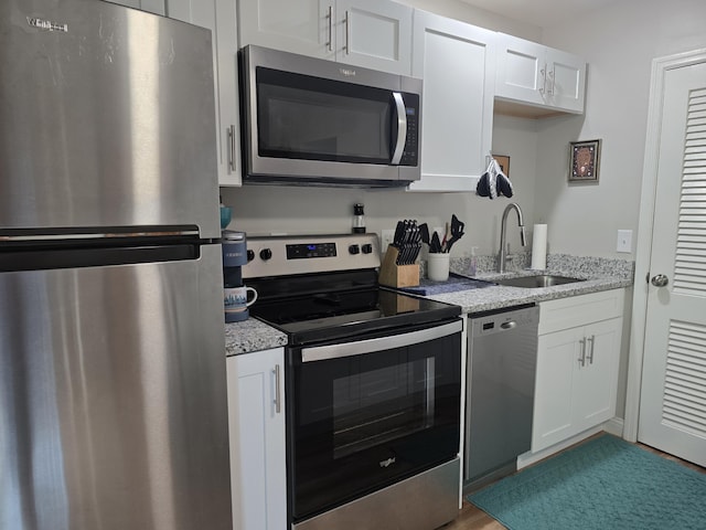7013 Curtis Way Unit 7013, Florence, KY 41042 - kitchen with appliances with stainless steel finishes, white cabinets, and light stone countertops