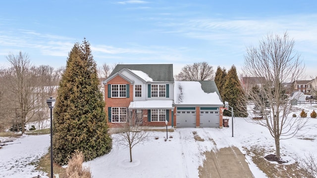 view of front of home with a garage and brick siding