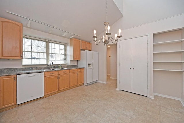 kitchen featuring hanging light fixtures, a sink, a notable chandelier, white appliances, and dark countertops