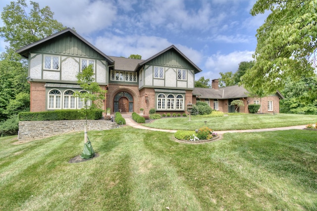 english style home featuring a front lawn