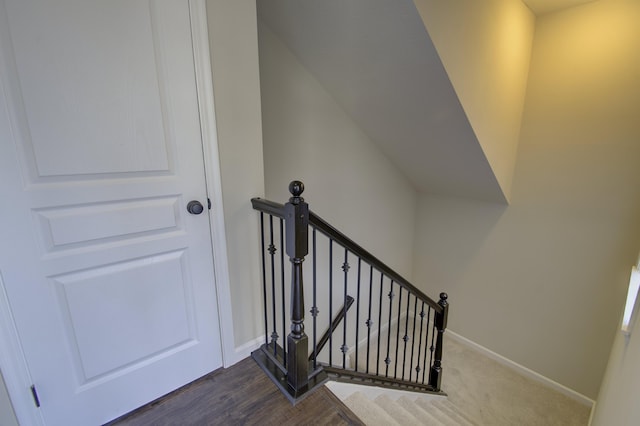 stairway with baseboards and wood finished floors