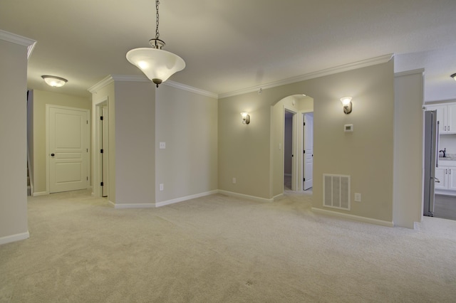 unfurnished room featuring visible vents, arched walkways, crown molding, and light colored carpet