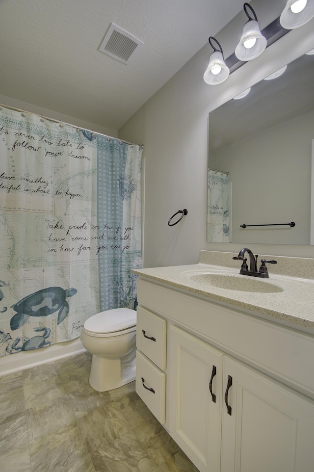 bathroom with visible vents, a shower with shower curtain, toilet, and vanity