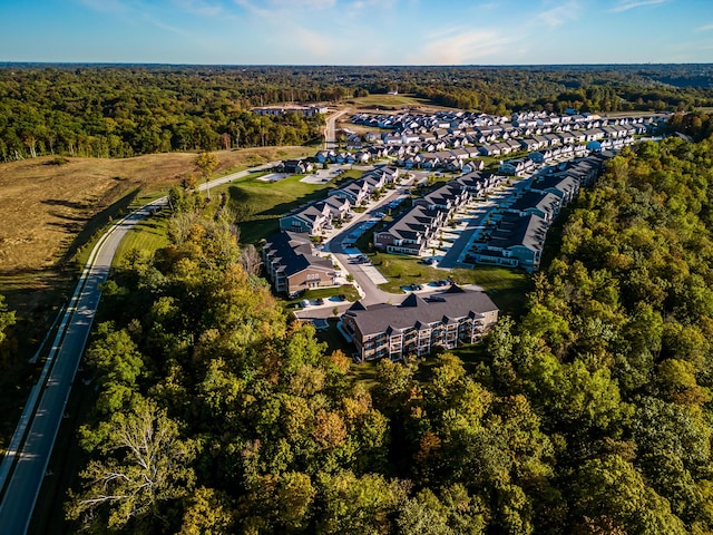 bird's eye view with a wooded view