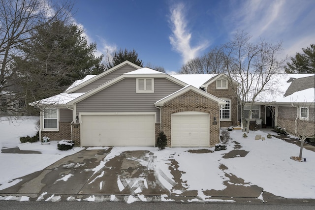 view of front of property with an attached garage and brick siding