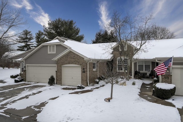 view of front of property with a garage and brick siding