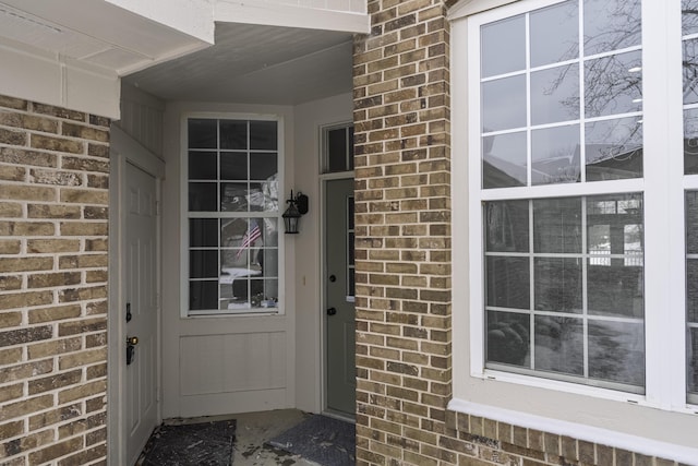 property entrance featuring brick siding