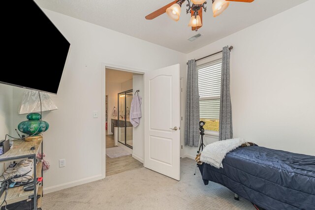 bedroom with baseboards, ceiling fan, visible vents, and light colored carpet