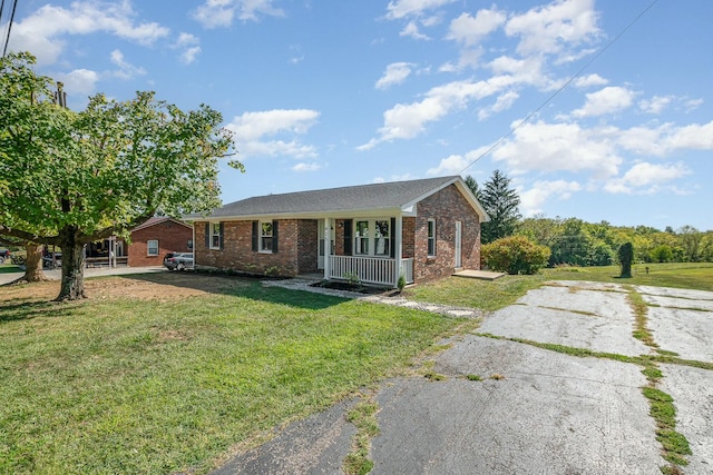 ranch-style house with a front yard and brick siding