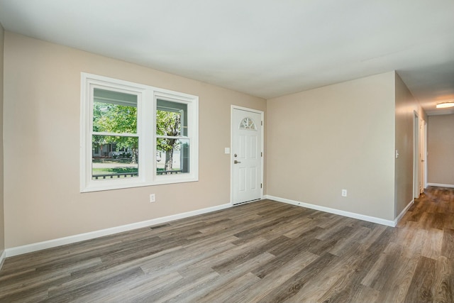 entrance foyer featuring dark wood-style floors, baseboards, and visible vents