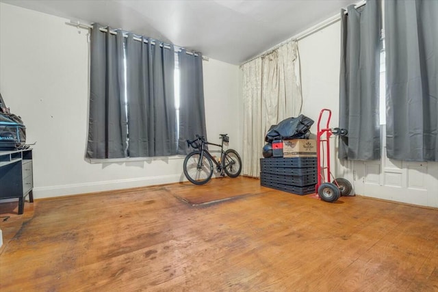 interior space featuring baseboards and wood finished floors