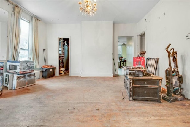 misc room with an inviting chandelier and baseboards