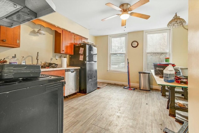 kitchen featuring stainless steel appliances, baseboards, light countertops, light wood-type flooring, and custom exhaust hood