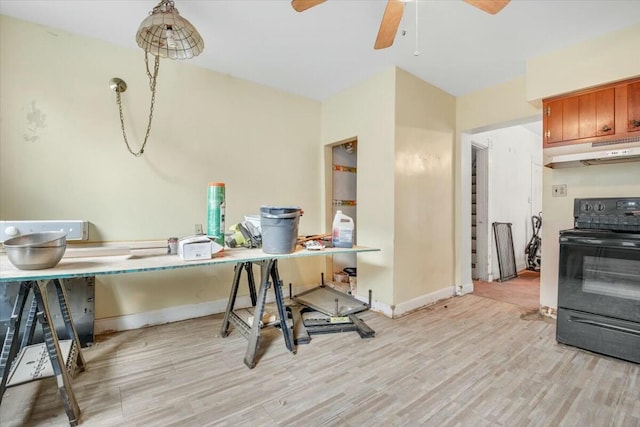 office space with light wood-style floors, ceiling fan, and baseboards