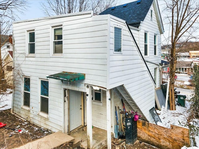 view of front of property with roof with shingles