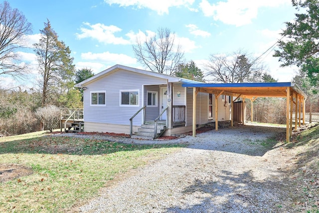 view of front of property with driveway and an attached carport