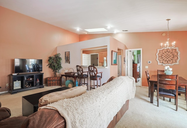 living area featuring light carpet, vaulted ceiling, baseboards, and an inviting chandelier