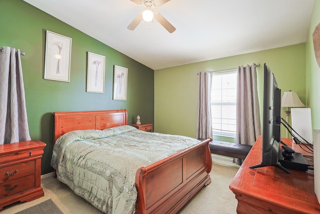 bedroom featuring ceiling fan, vaulted ceiling, and light colored carpet