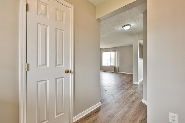 2041 Lafitte Ct, Union, KY 41091 - hallway with a textured ceiling, wood finished floors, and baseboards