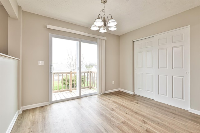 2041 Lafitte Ct, Union, KY 41091 - unfurnished dining area featuring baseboards, an inviting chandelier, and light wood-style flooring