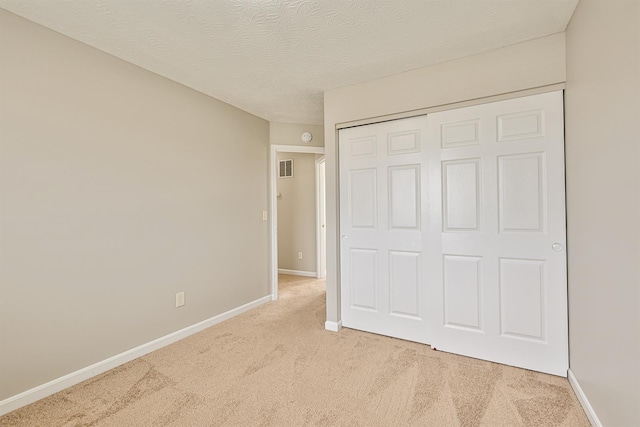 2041 Lafitte Ct, Union, KY 41091 - unfurnished bedroom featuring a closet, a textured ceiling, visible vents, baseboards, and light colored carpet