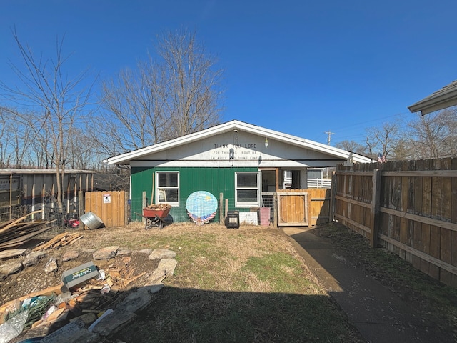 back of house featuring fence