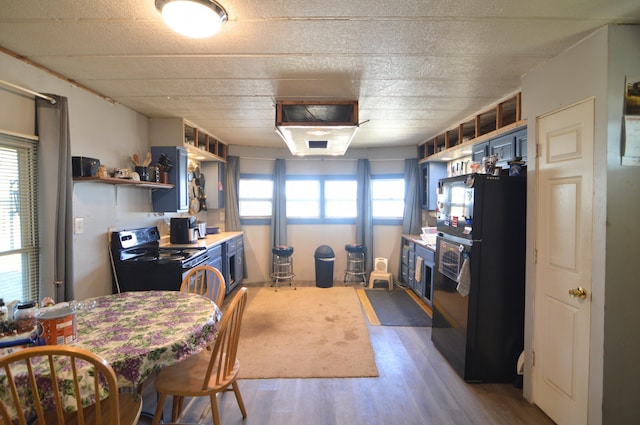 kitchen featuring open shelves, black appliances, wood finished floors, and blue cabinets