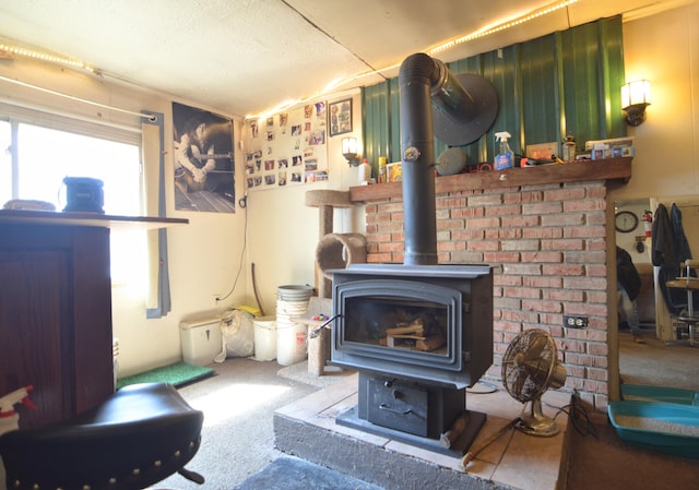 details featuring carpet, a wood stove, and a textured ceiling