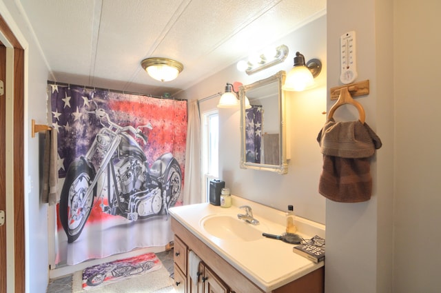 full bathroom featuring curtained shower, a textured ceiling, and vanity