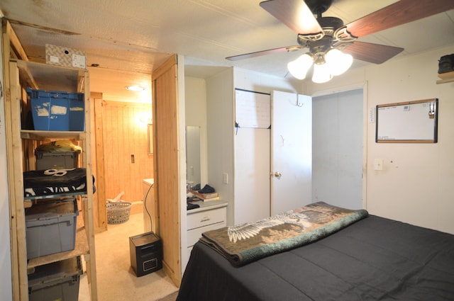 bedroom with a ceiling fan and light colored carpet