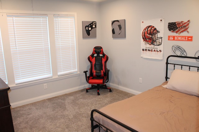 carpeted bedroom featuring baseboards